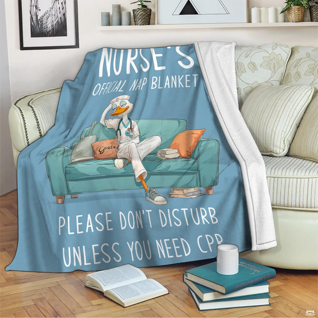 Full display of resting nurse duck cartoon throw blanket laid flat on light wooden floor