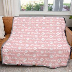 Close-up of elegant dog print bedding highlighting white puppy paws and cursive artwork on thematic accent pink.