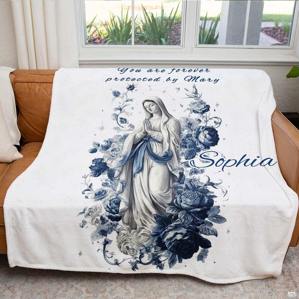 Blessed Mother blanket draped over an armchair beside a brightly lit window.