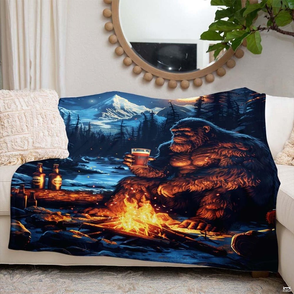 Bedroom styled with Bigfoot campfire mountain throw blanket displayed across rustic bedding