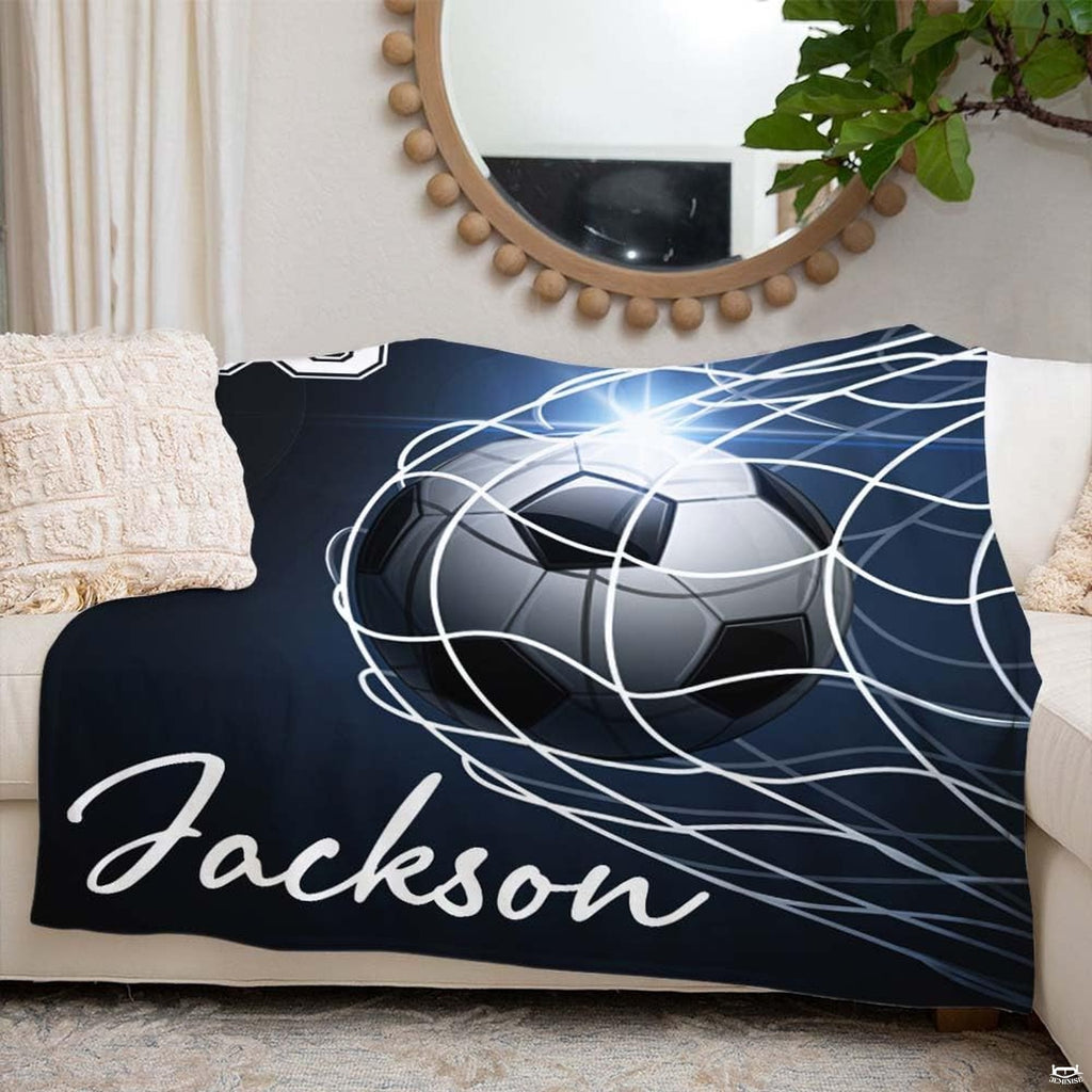 Person holding soccer ball in goal net illustration design blanket