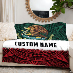 Folded Mexican flag themed throw blanket displayed on a wooden accent armchair