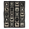 Gothic cameo throw blanket featuring black and cream tiled skulls, ghosts, bats, and ravens.