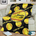 Fastpitch optic balls pattern fan blanket draped over sofa beside books