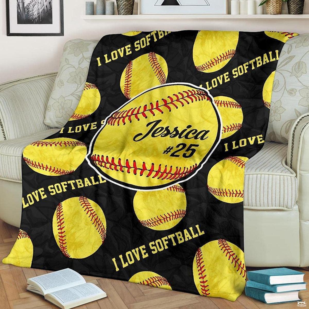 Fastpitch optic balls pattern fan blanket draped over sofa beside books