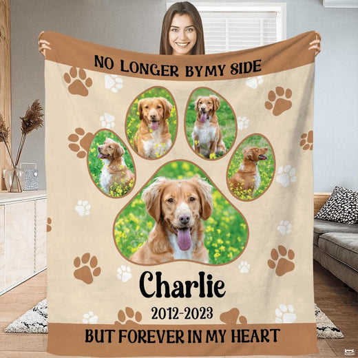 Front view of dog memorial paw print throw blanket held upright displaying giant paw collage artwork.