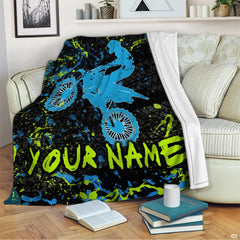 Airborne motocross dirt bike rider silhouette with neon splatters and tire tracks, view 2.
