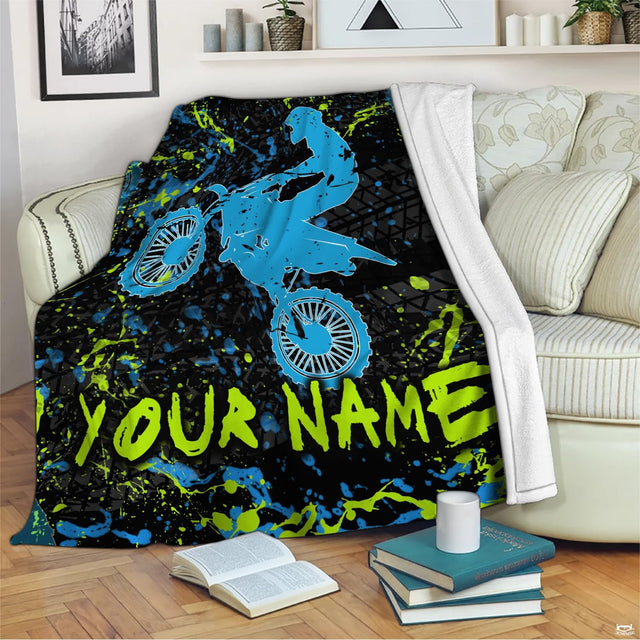 Airborne motocross dirt bike rider silhouette with neon splatters and tire tracks, view 2.