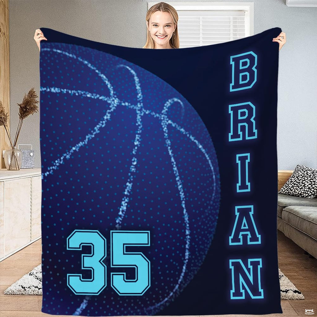 Close-up of glowing dotted basketball illustration and sleek seam arcs on navy sports theme bedroom bedding.
