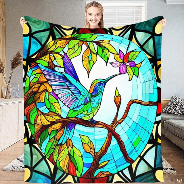 Stained glass hummingbird blanket featuring a colorful mosaic bird sipping blossom nectar.