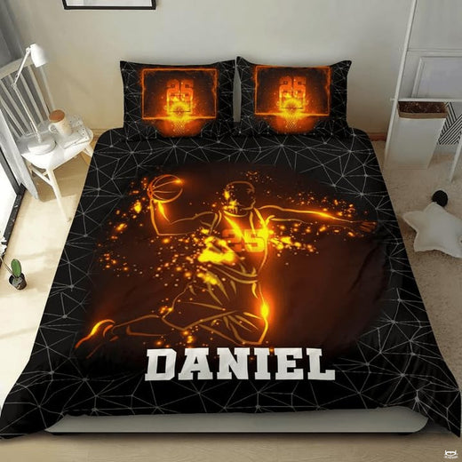 Fiery slam dunk basketball player sports bedding displaying glowing amber athlete and polygon mesh on black bed