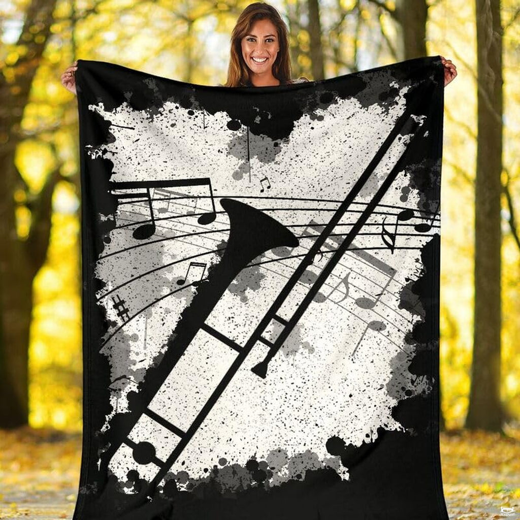 Trombone brass instrument throw blanket styled neatly across a living room sofa.