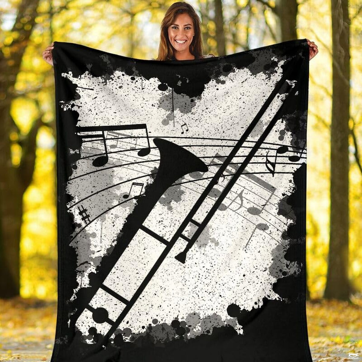 Trombone brass instrument throw blanket styled neatly across a living room sofa.