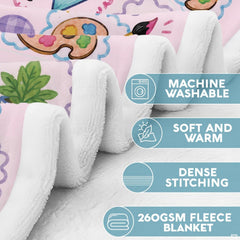 Draped view of pink teacher doodles throw blanket in a cozy study lounge setting