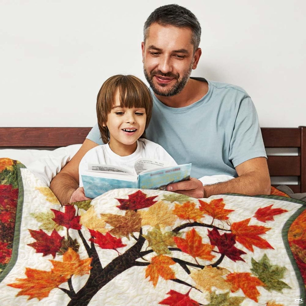 Close-up perspective of falling maple leaves and pumpkin on throw blanket