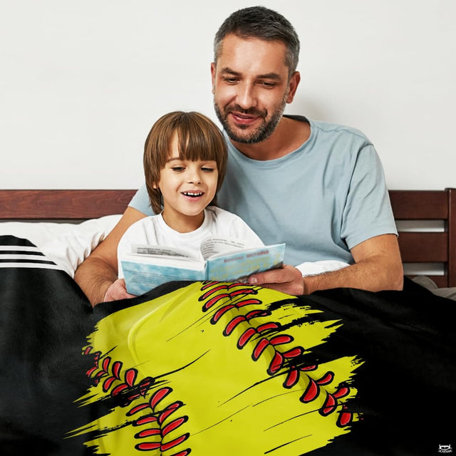 Adult and child reading in bed draped in distressed yellow sports graphic design.