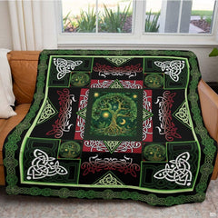Zoomed view of red and white zoomorphic flourishes and ornate Celtic patterns across the bedding design.