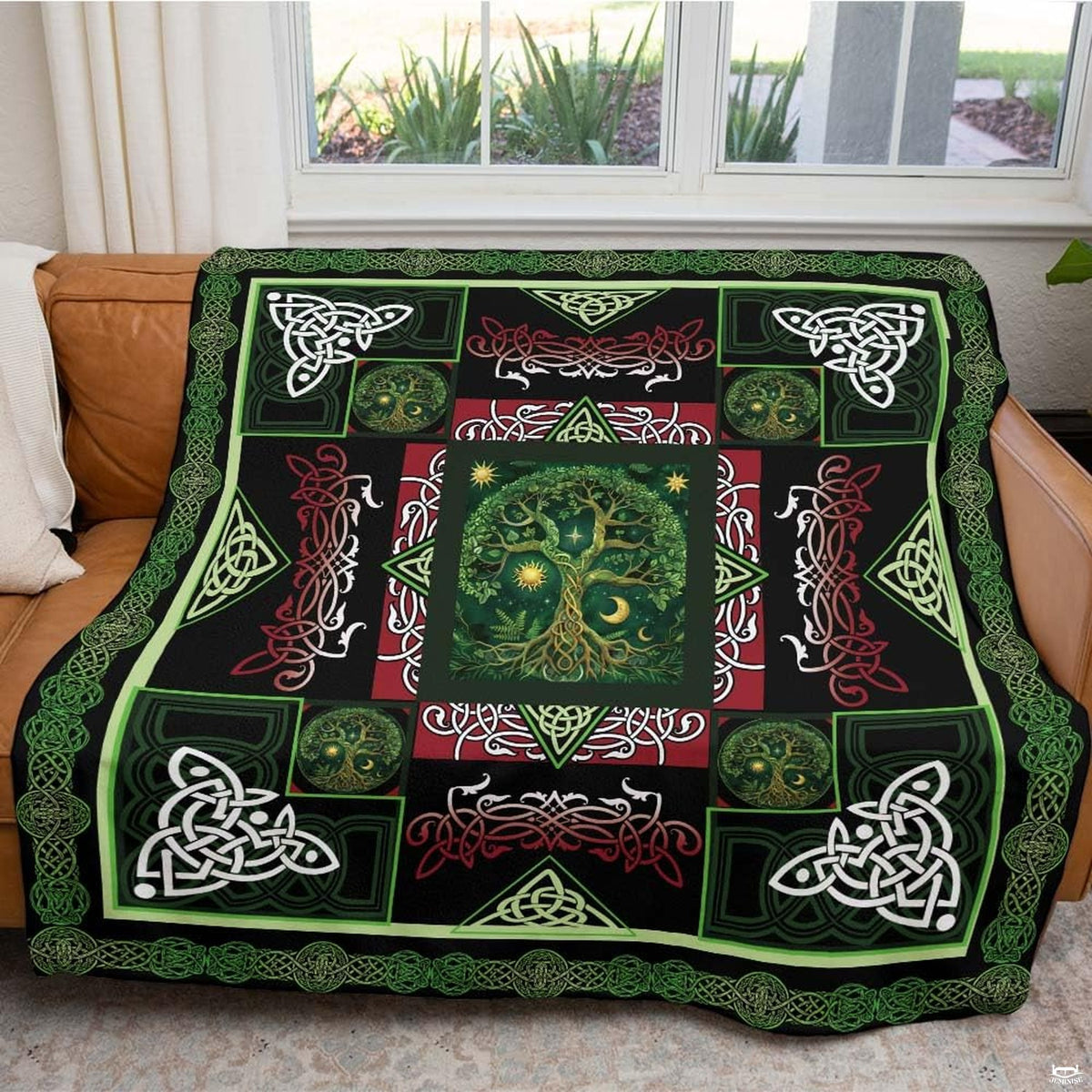 Zoomed view of red and white zoomorphic flourishes and ornate Celtic patterns across the bedding design.