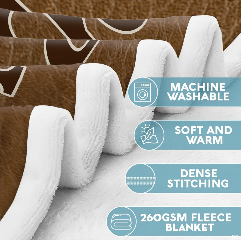 Whitetail buck wildlife throw blanket styled across a sofa in a rustic lodge.