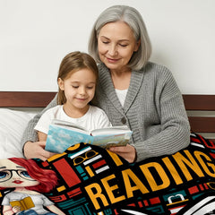 Detail view of colorful book spine patterns and glasses icons on reader throw blanket.
