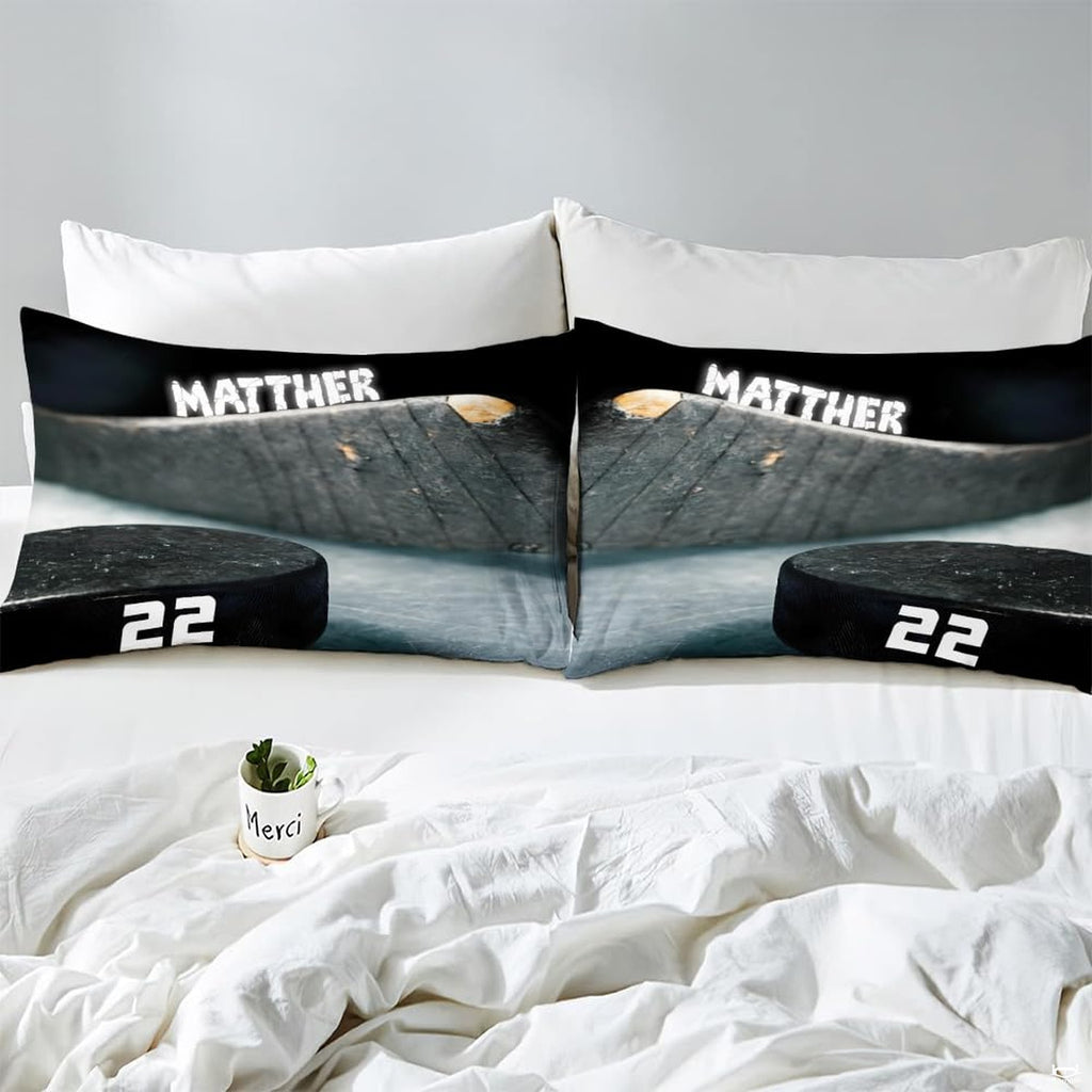 Side angle view of athletic winter sports bedding showing charcoal black and slate grey tones on mattress