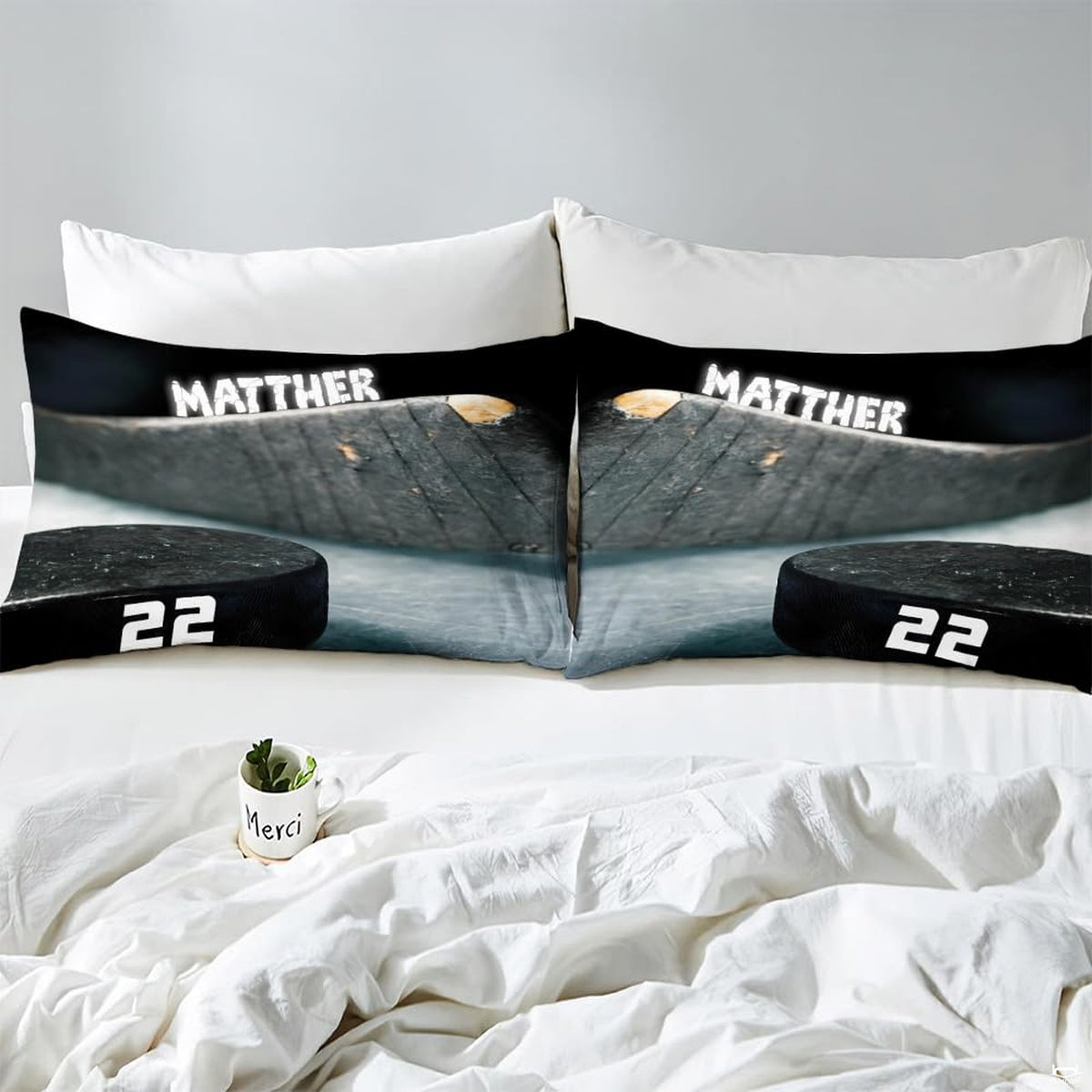 Side angle view of athletic winter sports bedding showing charcoal black and slate grey tones on mattress
