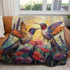Stained glass hummingbird throw blanket draped over a living room couch.