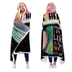 Front and rear perspectives of a model wearing the watercolor softball sports hooded blanket.