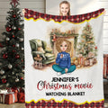 Front view of Christmas movie watching throw blanket held upright showcasing watercolor hearth artwork.