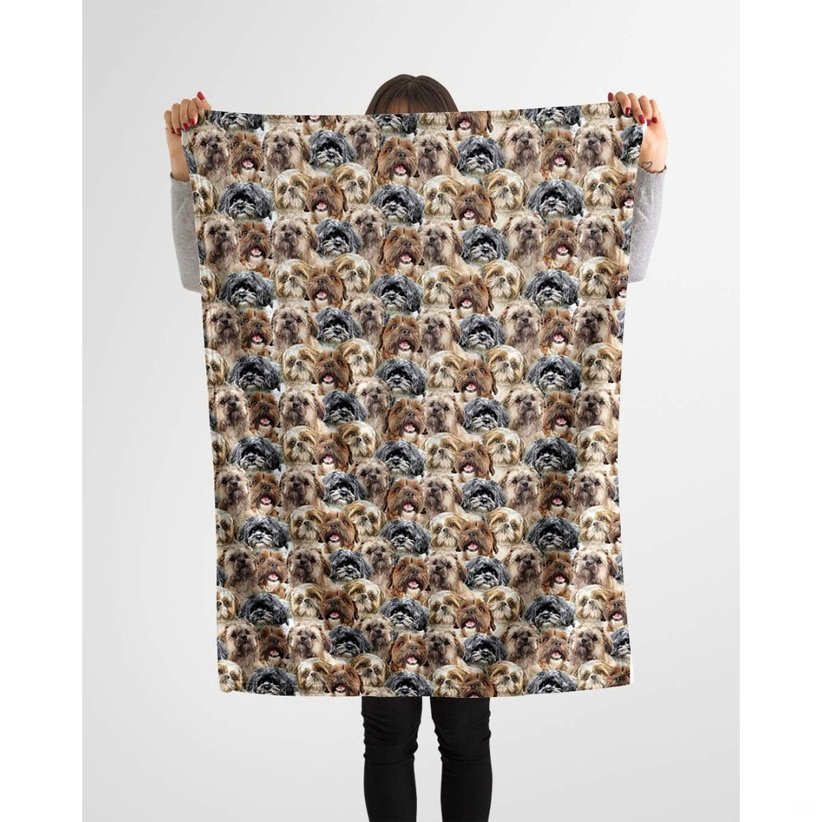 Model holding up a repeating Shih Tzu canine blanket against a plain background.
