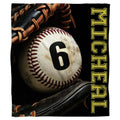 Authentic baseball in a black fielder glove beside vertical gold varsity lettering, view 1.