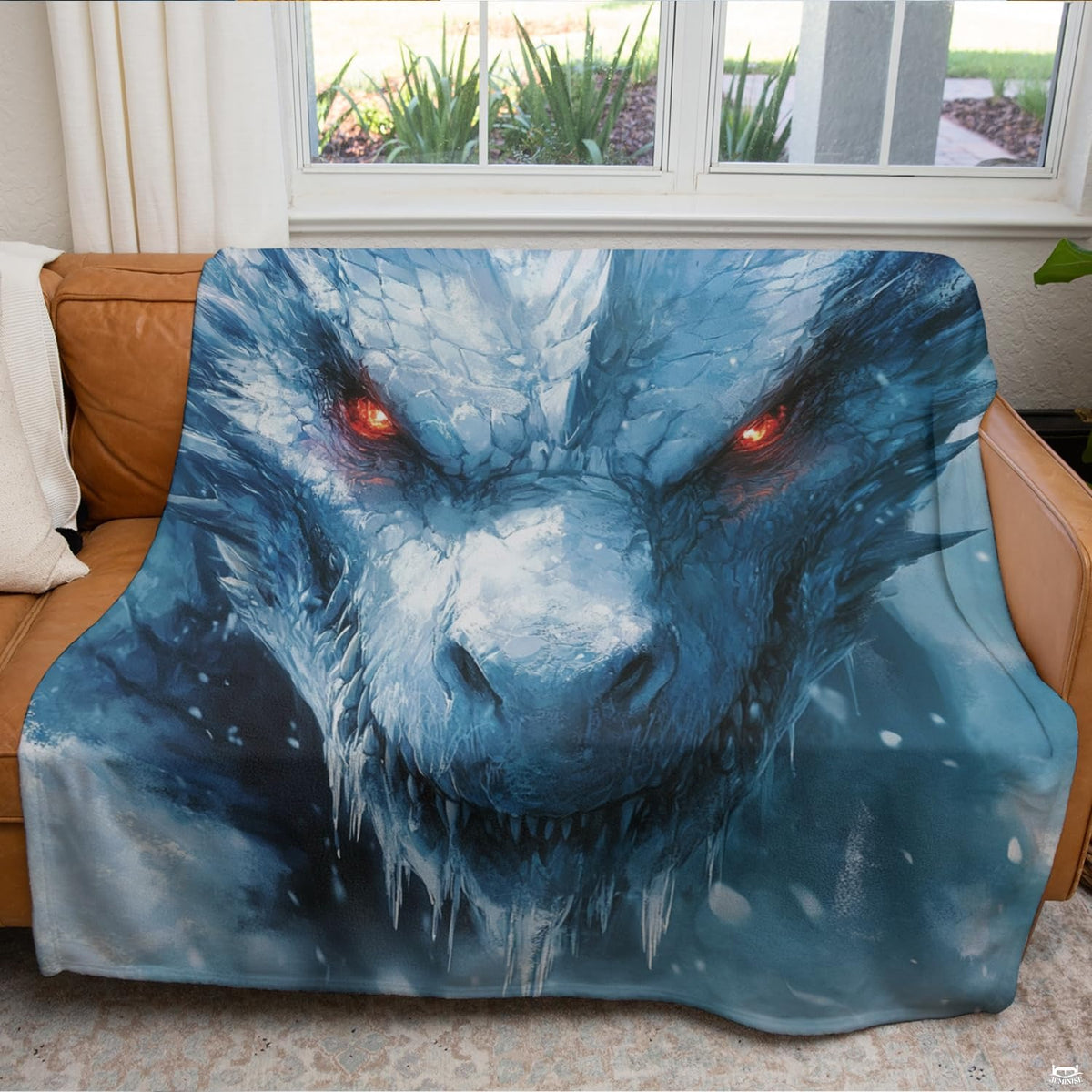 Ice dragon fantasy throw blanket draped neatly across a living room couch.