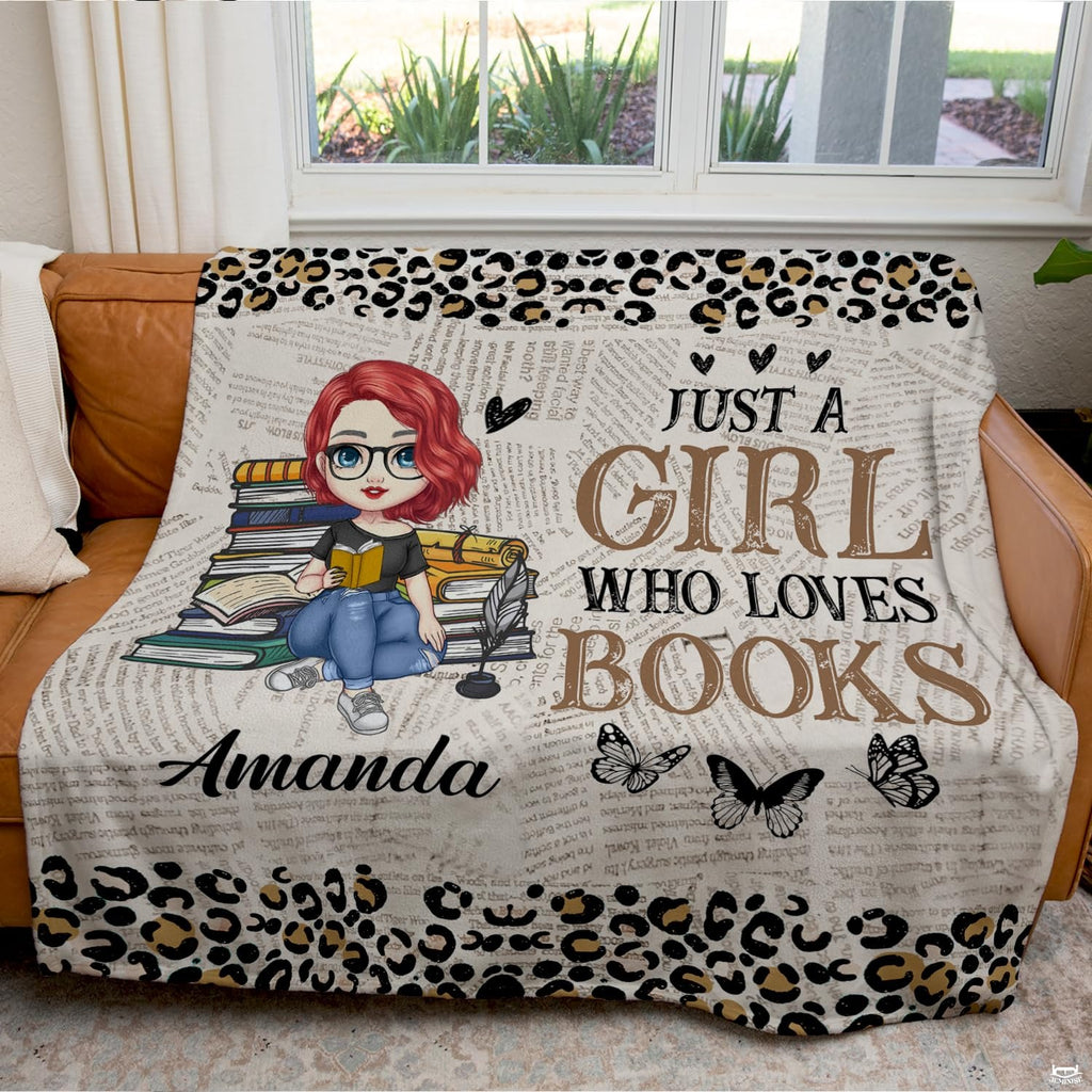 Detail view of illustrated bookworm character and glasses on literary throw blanket.