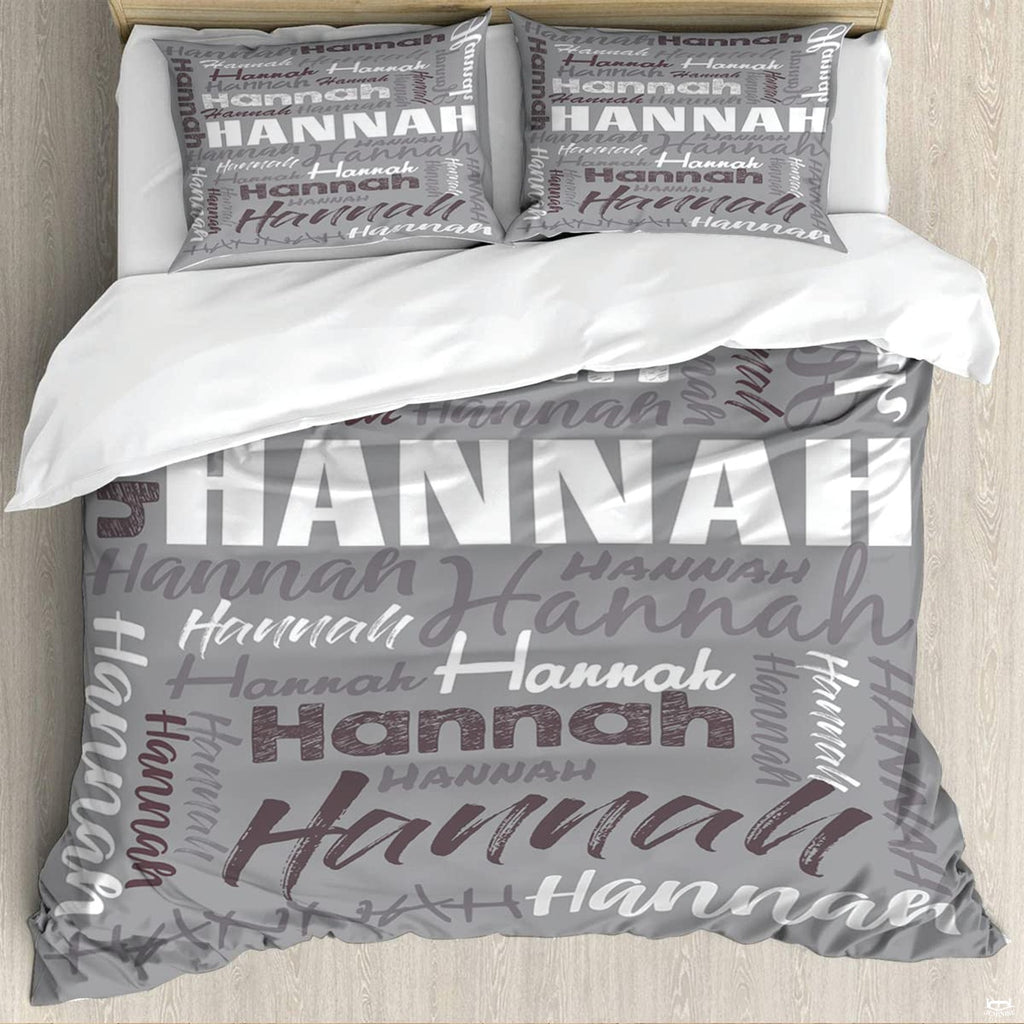 Bedding set featuring diagonal cursive script and distressed typography on neutral grey background.