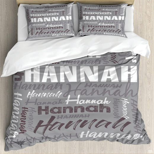 Bedding set featuring diagonal cursive script and distressed typography on neutral grey background.