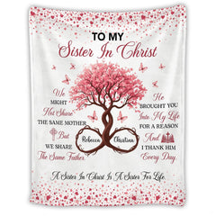 Close view of open Bible illustration with cross and intertwined floral wreath accents.