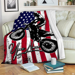 Dirt bike rider silhouette jumping over distressed American flag stars and stripes, view 2.