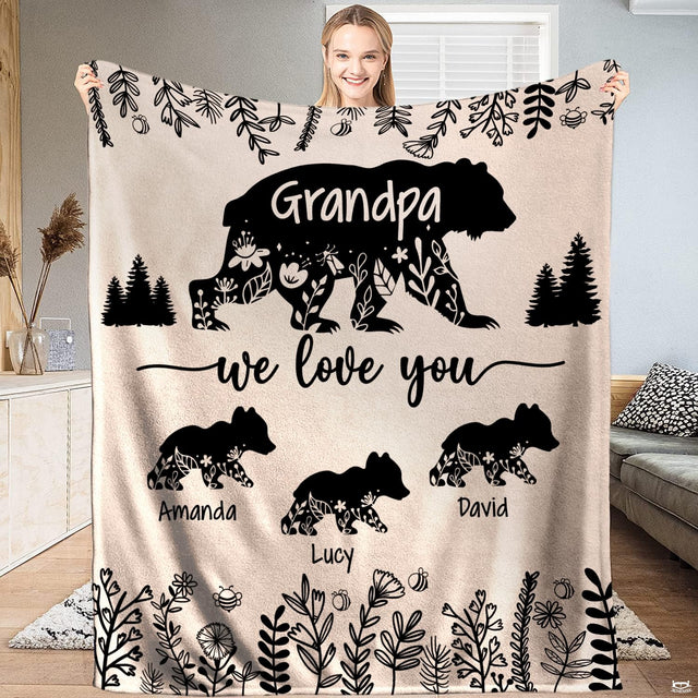 Full view of throw blanket displaying floral cutout bear silhouettes, three cubs, pine trees, and wildflowers.