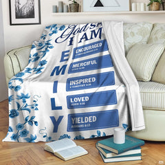 Close-up of the blue floral botanical border, navy Scripture calligraphy, and Bible chapter citations on a blanket