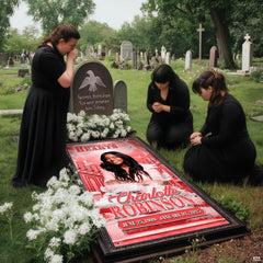Mourners gathered in prayer beside installed celestial dove memorial blanket at cemetery site