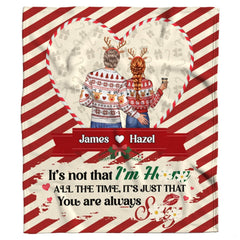 Holiday couple inside candy cane heart frame on diagonal peppermint stripes, view 2.