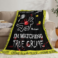 Crime scene throw blanket draped over living room sofa beneath round wall mirror