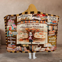 Reader throw blanket draped over a armchair near a home library bookshelf