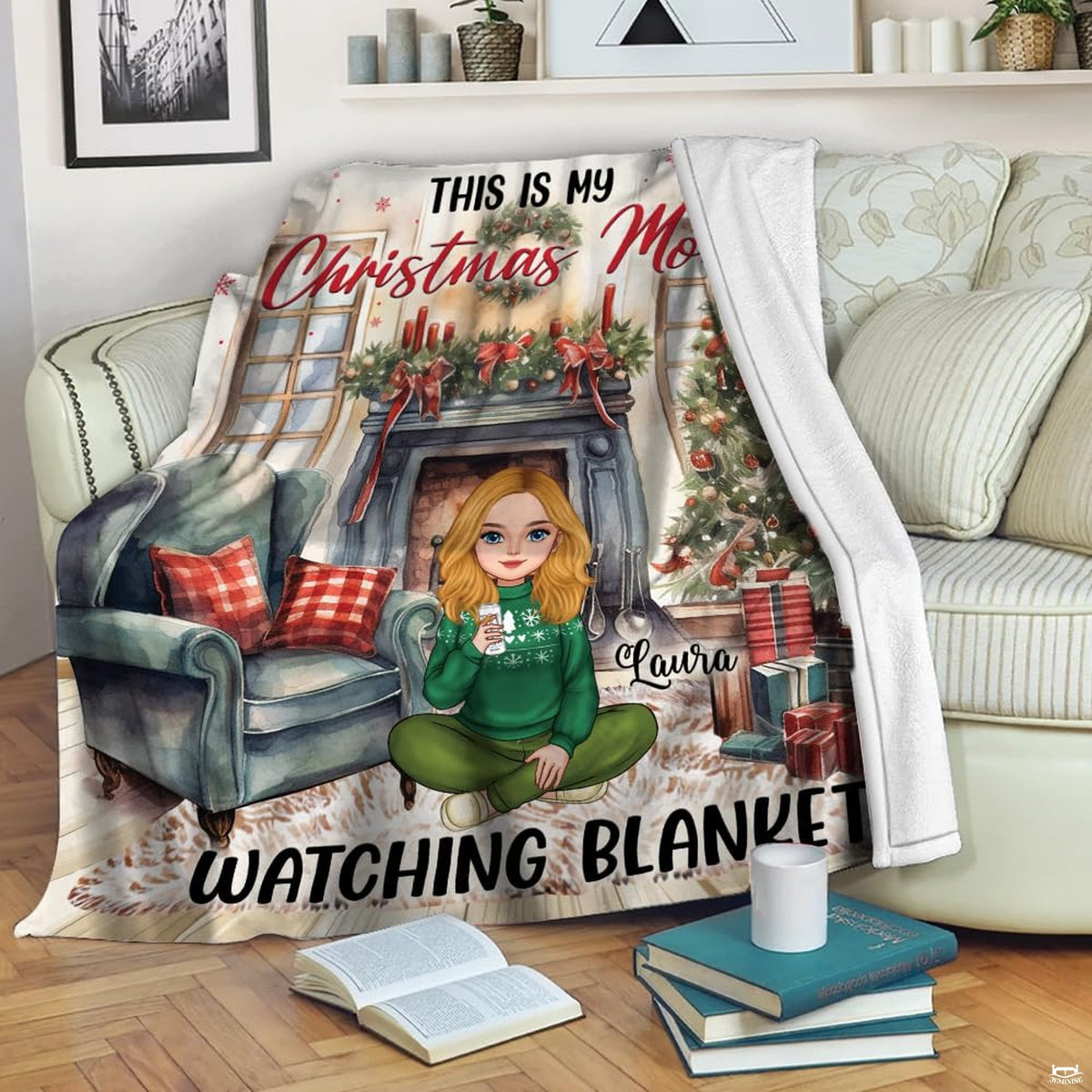 Living room staging of Christmas holiday throw blanket draped across a floral armchair beside books.