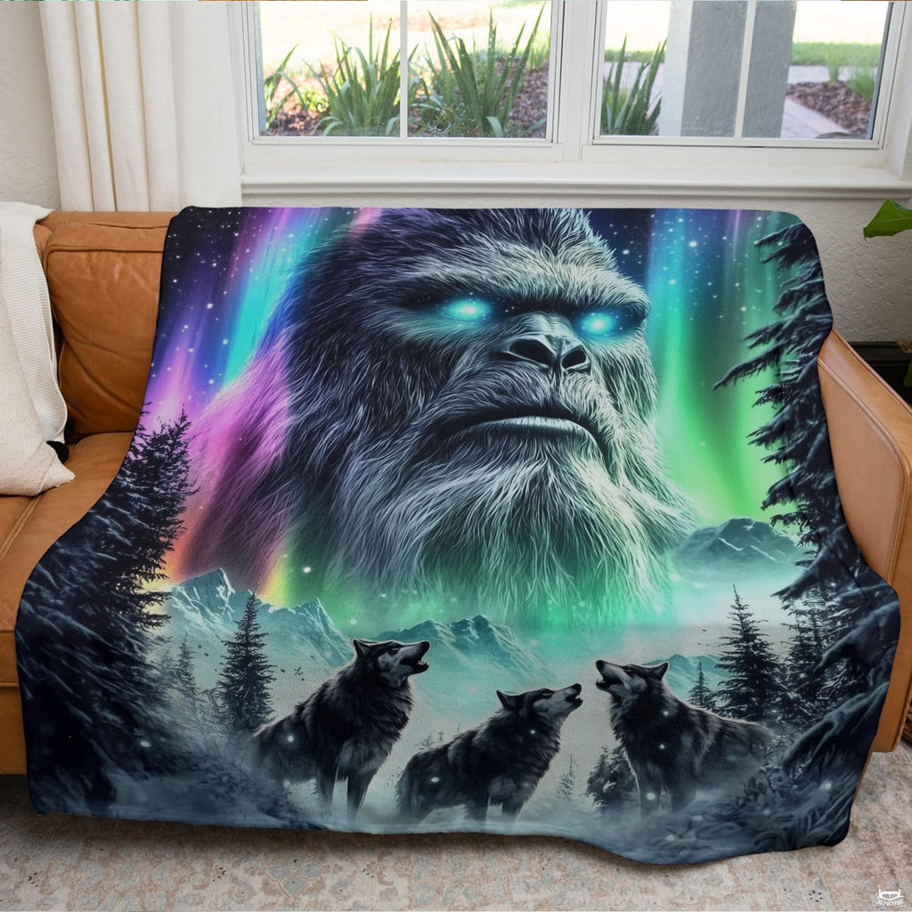 Textile arranged on living room couch displaying cosmic Sasquatch and three wolves in snow.