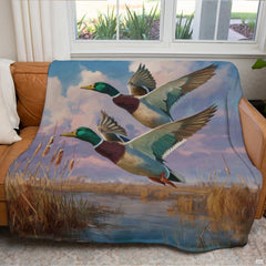 Two mallard ducks soaring over golden wetland marsh cattails at sunset, view 4.