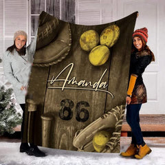 Rustic wood fastpitch softball equipment blanket held upright by models outdoors