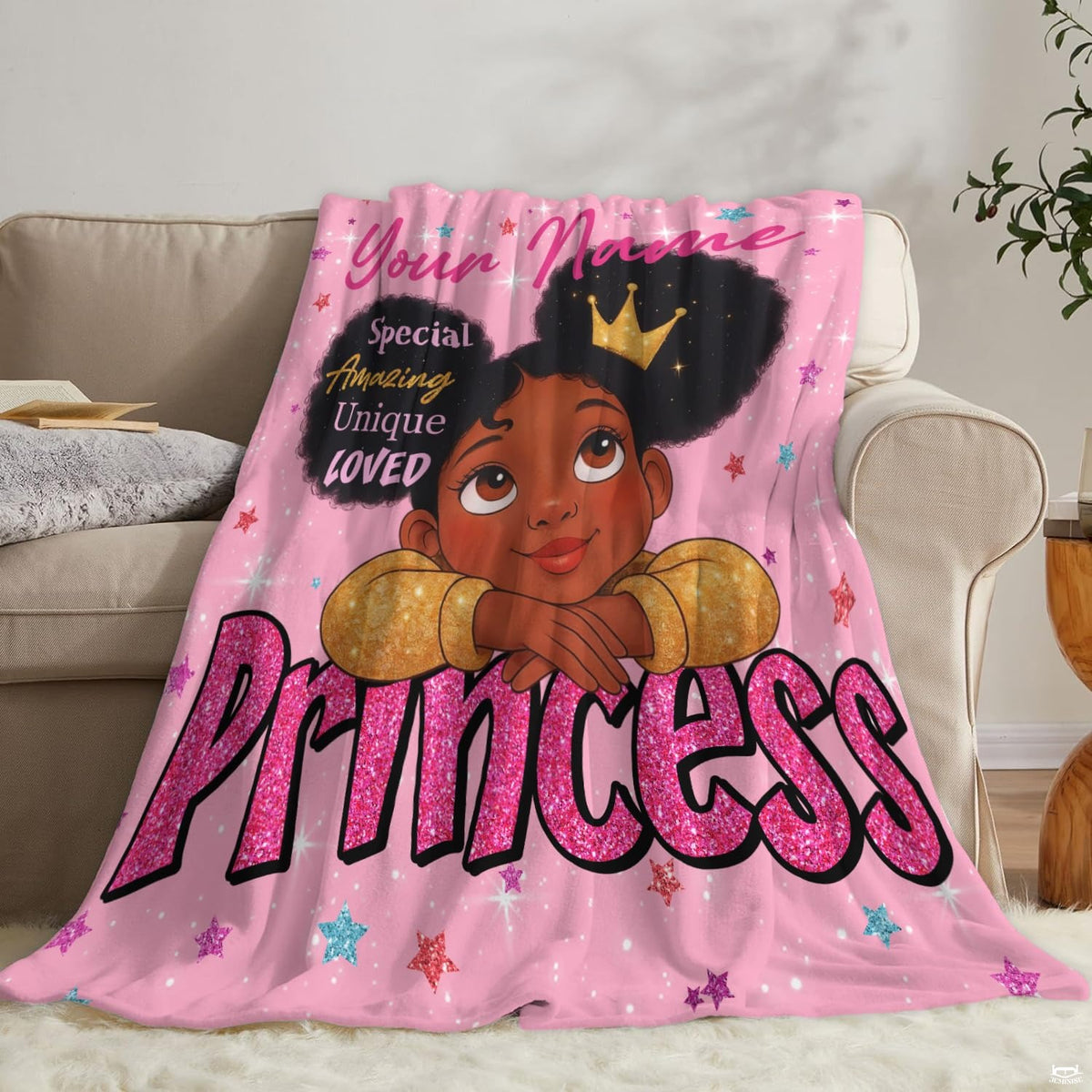 Lifestyle setting displaying the pink girl throw blanket neatly folded on an armchair.