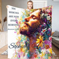 Jesus Christ blanket showing serene profile portrait surrounded by colorful wildflowers.