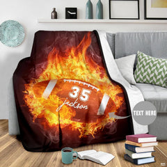Close view of fiery flames and football laces on graphic blanket